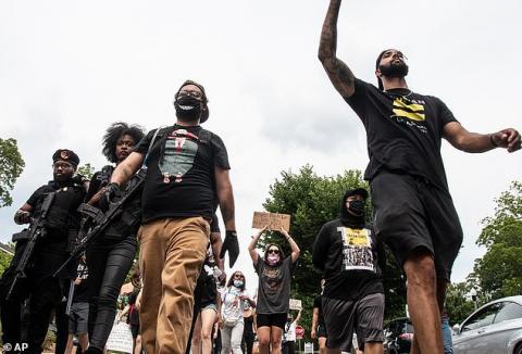 Armed New Black Panthers march to protect demonstrators as they join peaceful protests in Georgia